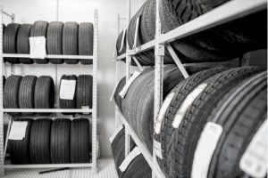 Tires stored on racks in a clean, organized storage facility, labeled and ready for seasonal use.